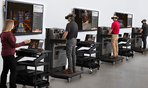 Forklift operators completing virtual reality forklift safety training on bucks.